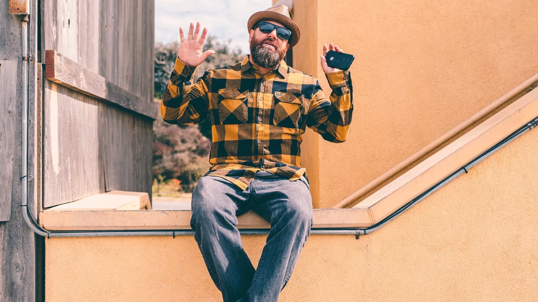 Jason "Willz" Williams sits on a handrail, holding up his hands