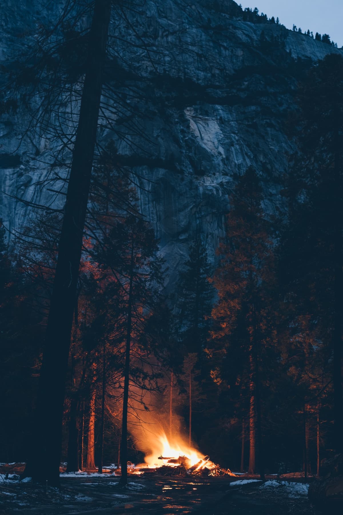 A bonfire glows in the winter evening at Yosemite National Park